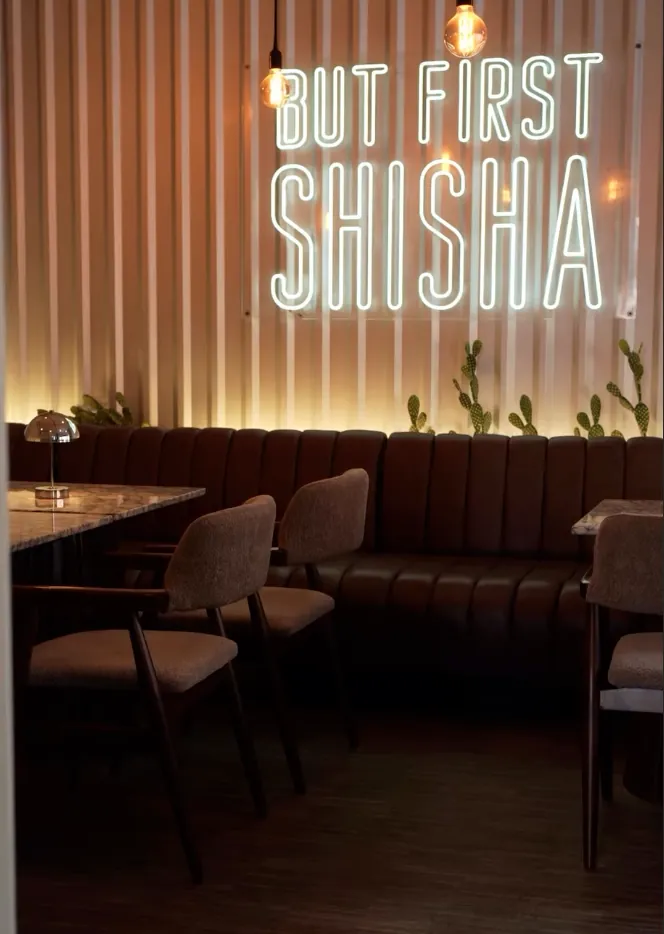 Lounge mit Neon-Schriftzug But First Shisha